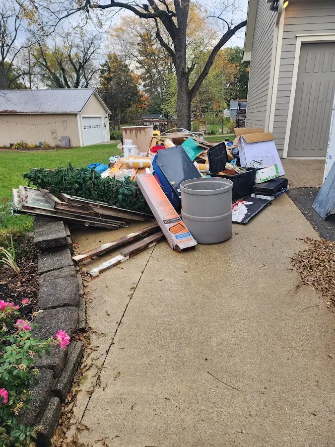 Dumpster being loaded with debris for Commercial Dumpster Rental in Port Huron